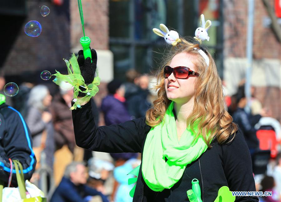 A reveller makes soap bubbles during the 2016 Toronto Beaches Lions Easter Parade in Toronto, Canada, March 27, 2016.