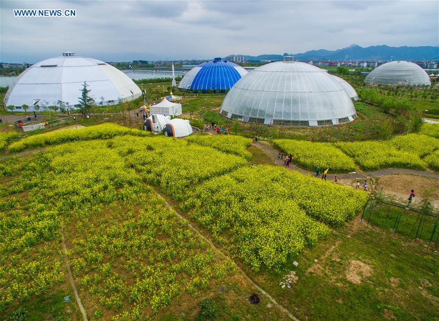 An aerial photo taken on April 9, 2016 shows people visiting dome greenhouses in Tiantai County, east China's Zhejiang Province.