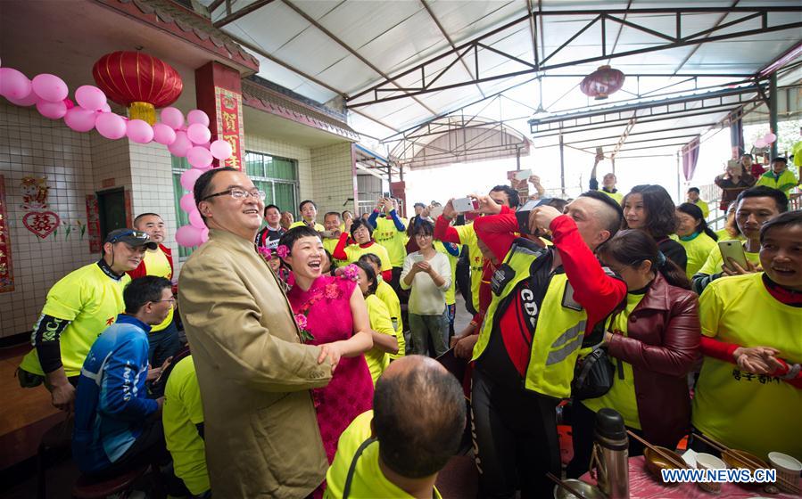 Riders take photos of the couple Zeng Di and Wang Lixia during the wedding in Changqiu village of Pujiang county in Chengdu, capital of southwest China's Sichuan Province, April 9, 2016.