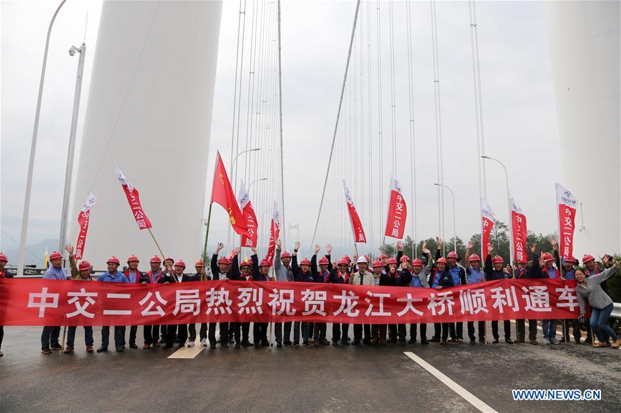 Members of construction units for Longjiang grand bridge celebrate the opening of the bridge in southwest China's Yunnan Province, April 20, 2016.