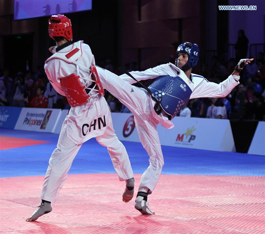 Zhao Shuai (L) of China competes against Saurav of India in the men's -63kg category in the 22nd Asian Taekwondo Championships in Pasay City, the Philippines, April 19, 2016. 