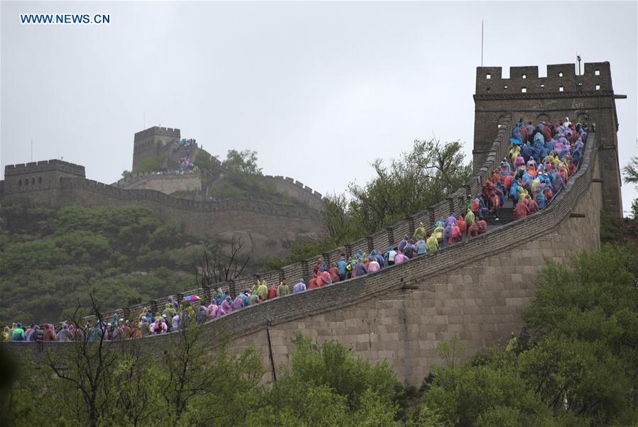 Tourists visit the Badaling Great Wall on a rainy day in Beijing, capital of China, May 2, 2016.