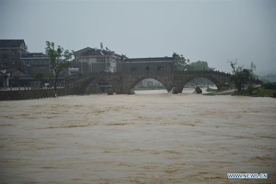 Floods run through an ancient bridge in Lichuan County, east China's Jiangxi Province, May 9, 2016. 