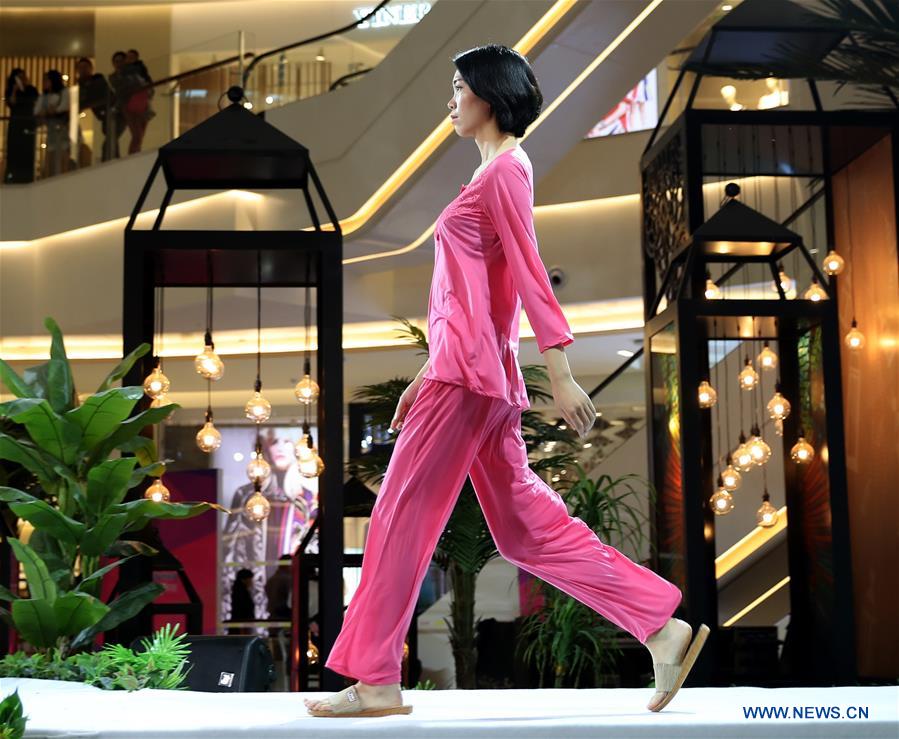 A child model presents a Babby Angie children's garment at 'vogue Zhucheng ' fashion show during the 16th China (Qingdao)International Fashion Week in Qingdao, east China's Shandong Province, May 12, 2016. 