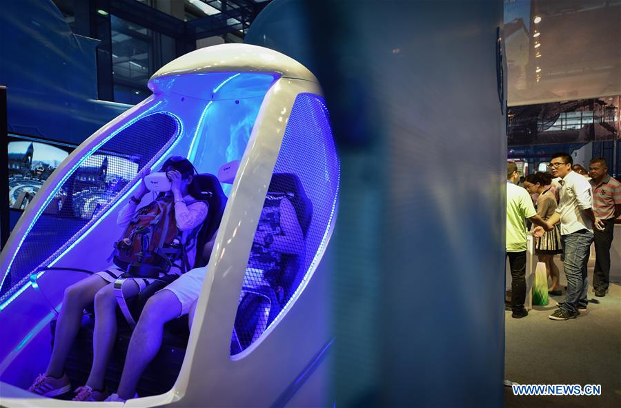 Visitors try the games with virtual reality (VR) devices at the 12th China (Shenzhen) International Cultural Industries Fair in Shenzhen, south China's Guangdong Province, May 13, 2016.