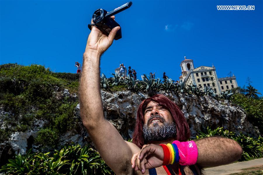 A man records a march against homophobia with a camcorder in Havana, capital of Cuba, on May 14, 2016.