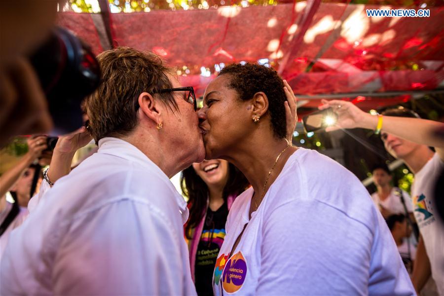 A lesbian couple kiss after a march against homophobia, in Havana, capital of Cuba, on May 14, 2016. 