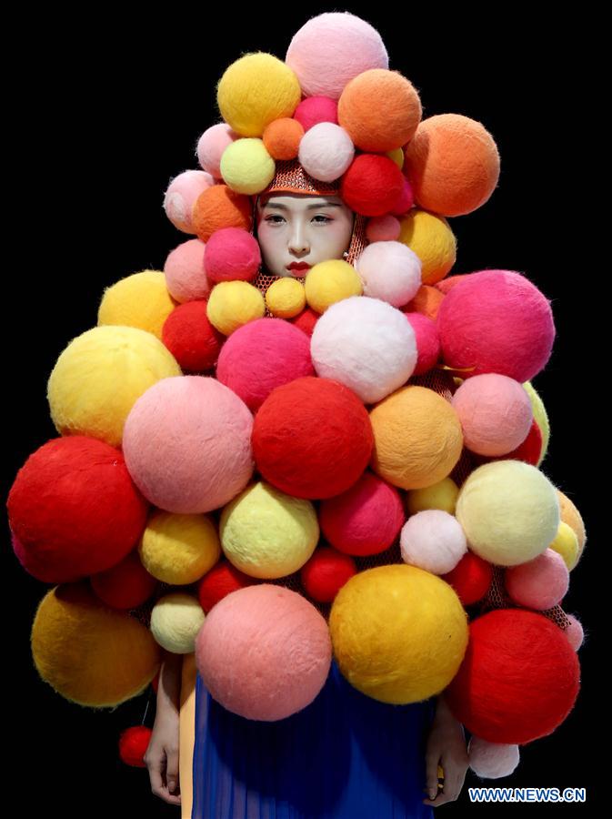 A model shows a creation of graduates from the Southwest University during the China Graduate Fashion Week in Beijing, capital of China, May 17, 2016. 