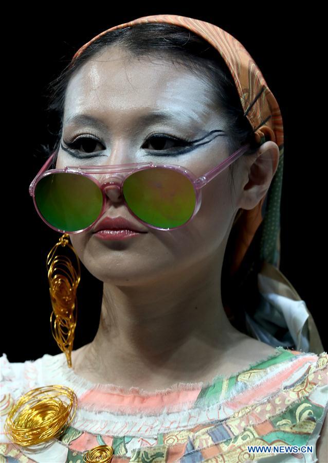 A model shows a creation of graduates from the Southwest University during the China Graduate Fashion Week in Beijing, capital of China, May 17, 2016.