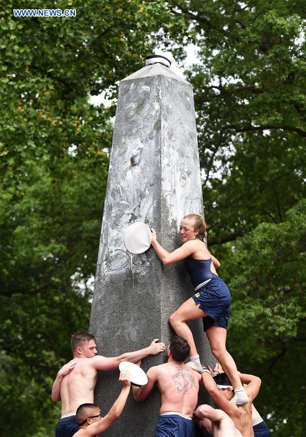 Plebes make a human wall to climb the Herndon Monument which is covered with vegetable shortening, at the U.S. Naval Academy (USNA) in Annapolis, Maryland, the United States, May 23, 2016.