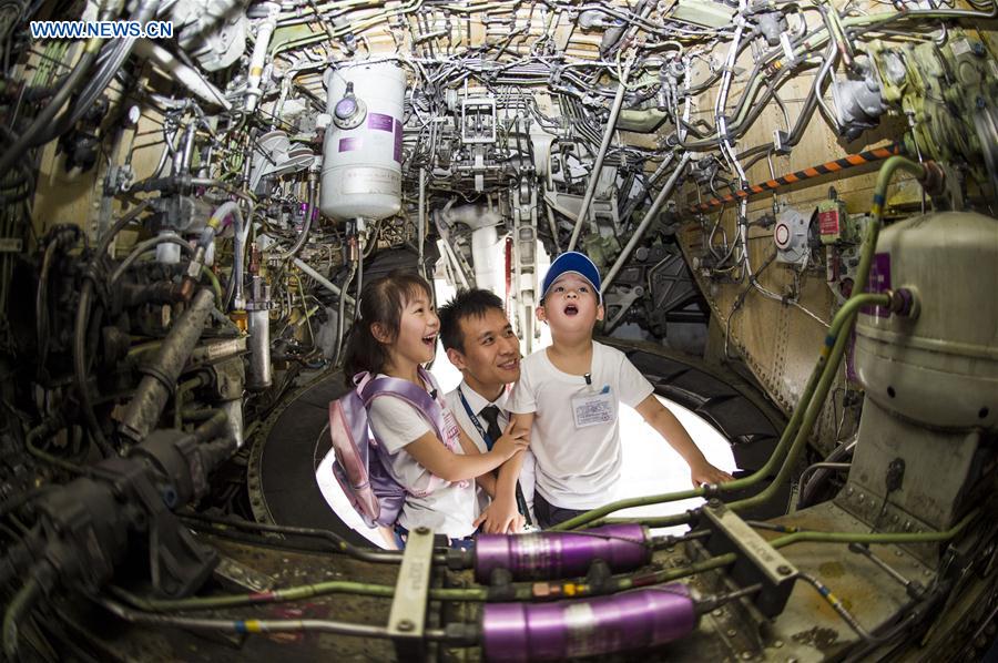 Children are amazed by the interior structure of an airliner during an aviation-themed visit in Wuhan, capital of central China's Hubei Province, May 30, 2016. 