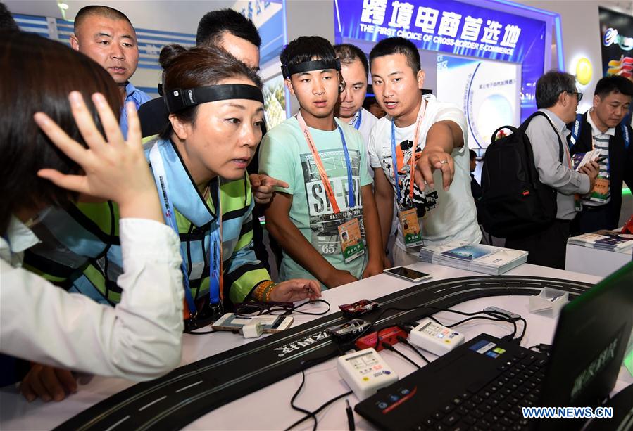 Visitors experience brain wave vehicles at the fourth China Beijing International Fair for Trade in Services in Beijing, capital of China, May 30, 2016.