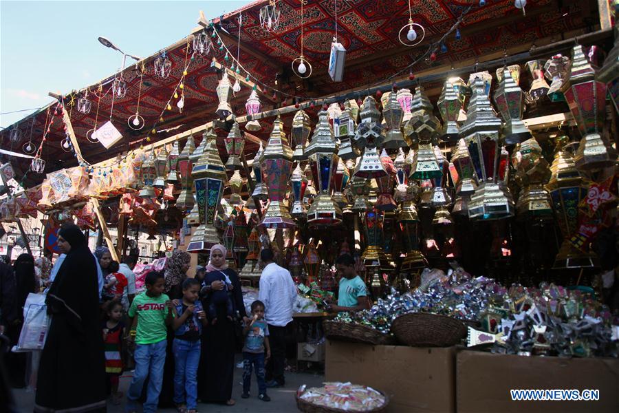 Egyptian people are seen at a Ramadan lantern shop in Cairo, Egypt on May 28, 2016. 