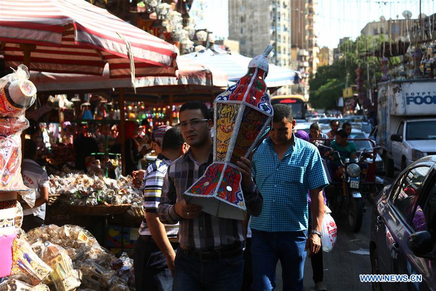 Egyptian people are seen at a Ramadan lantern shop in Cairo, Egypt on May 28, 2016. 