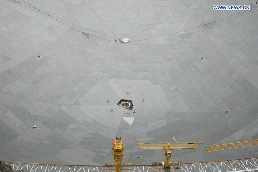 The last triangular panel to the reflector of the Five-hundred-meter Aperture Spherical Telescope (FAST) is being installed in Pingtang County, southwest China's Guizhou Province, July 3, 2016.