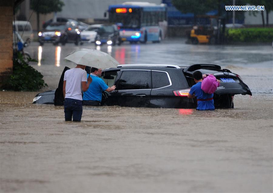 A vehicle is stranded on a flooded road in Jiujiang City, east China's Jiangxi Province, July 2, 2016. 