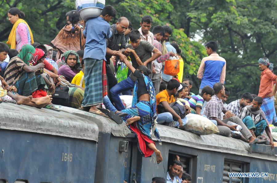 Passengers travel on top of a train leaving for their hometowns for the upcoming Eid al-Fitr festival in Dhaka, Bangladesh, July 5, 2016.