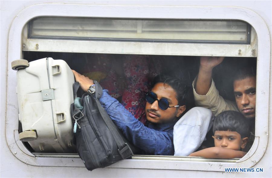 Passengers travel on top of a train leaving for their hometowns for the upcoming Eid al-Fitr festival in Dhaka, Bangladesh, July 5, 2016.