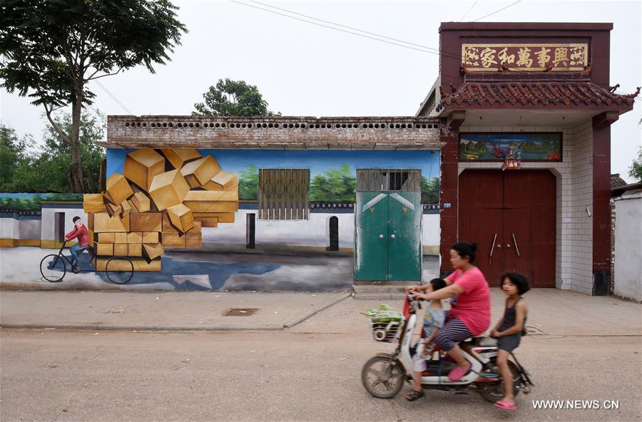 This year, local government decorated the Qiannanbu village with cultural graffiti works to improve the scenery. 