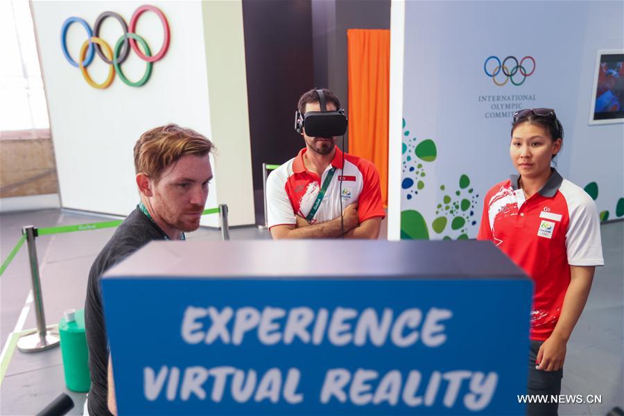 Members of the delegation of Singapore watch VR film at the Olympic village in Rio de Janeiro, Brazil, on Aug. 2, 2016. 