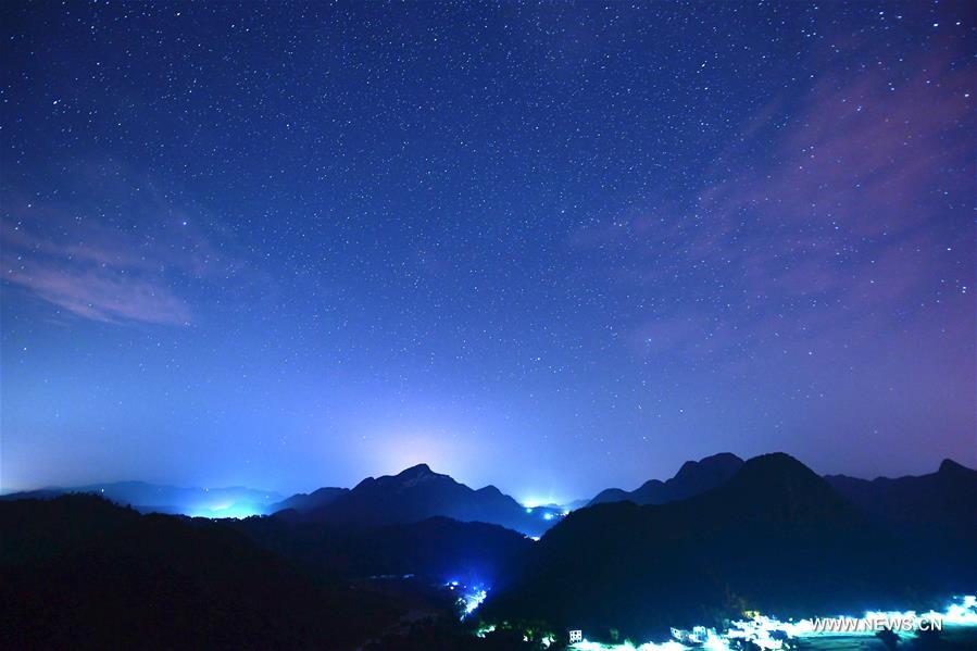 Photo taken on Aug. 25, 2016 shows starry sky in Jiulong Waterfall Scenic Spot of Luoping, southwest China's Yunnan Province.