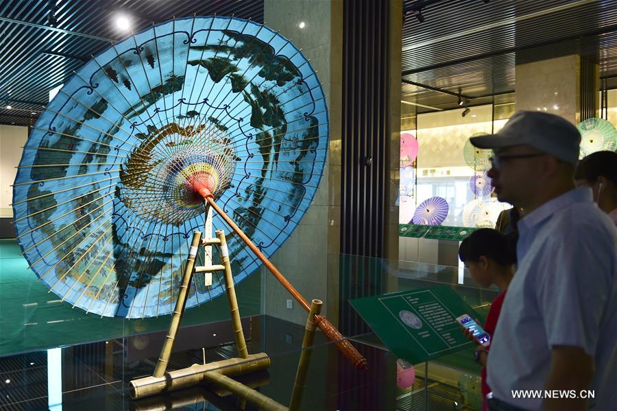 Traditional materials and tools used for making silk umbrellas are displayed during a West Lake silk umbrella show in Hangzhou, capital of east China's Zhejiang Province, Aug. 26, 2016. 