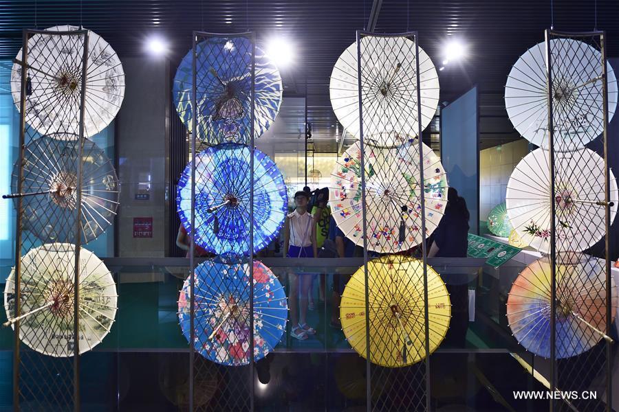 Traditional materials and tools used for making silk umbrellas are displayed during a West Lake silk umbrella show in Hangzhou, capital of east China's Zhejiang Province, Aug. 26, 2016. 