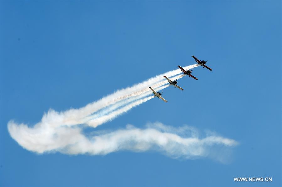 Planes take part in the aerobatics performance at an international general aviation convention in Zhangye City, northwest China's Gansu Province, Aug. 26, 2016.