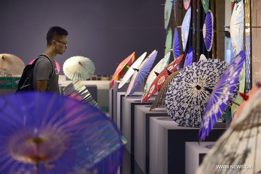 Traditional materials and tools used for making silk umbrellas are displayed during a West Lake silk umbrella show in Hangzhou, capital of east China's Zhejiang Province, Aug. 26, 2016. 