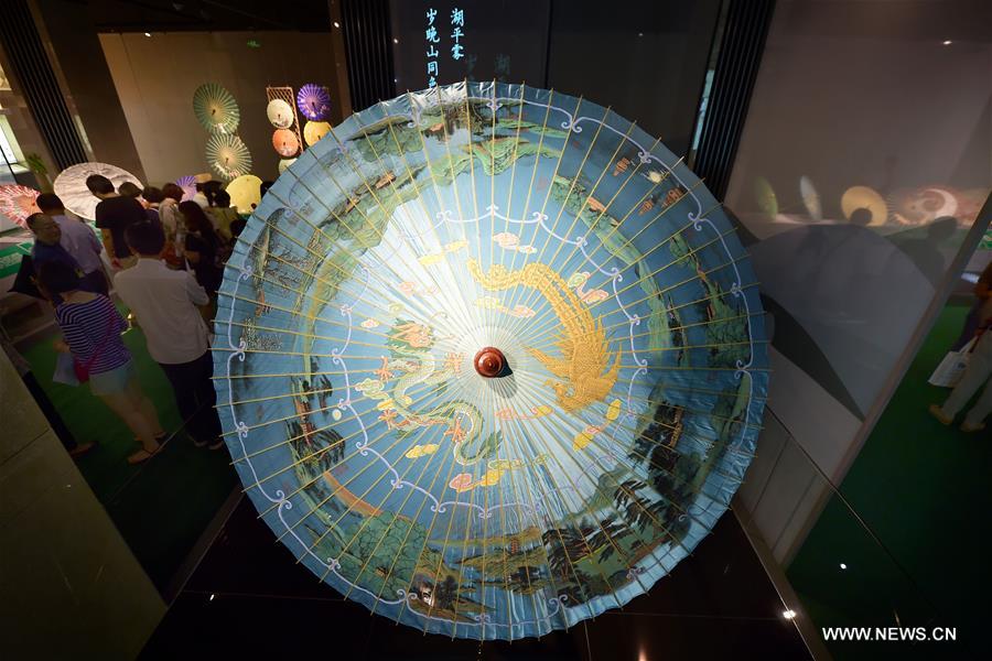 Traditional materials and tools used for making silk umbrellas are displayed during a West Lake silk umbrella show in Hangzhou, capital of east China's Zhejiang Province, Aug. 26, 2016. 