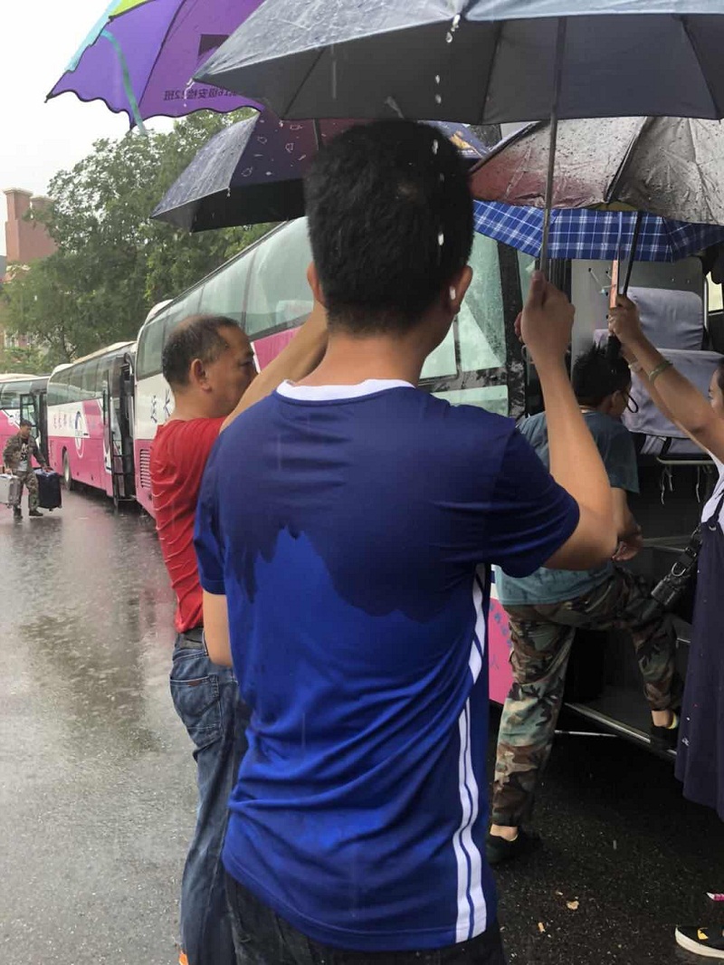 成都一学校老师暴雨中筑人墙撑伞为学生护行