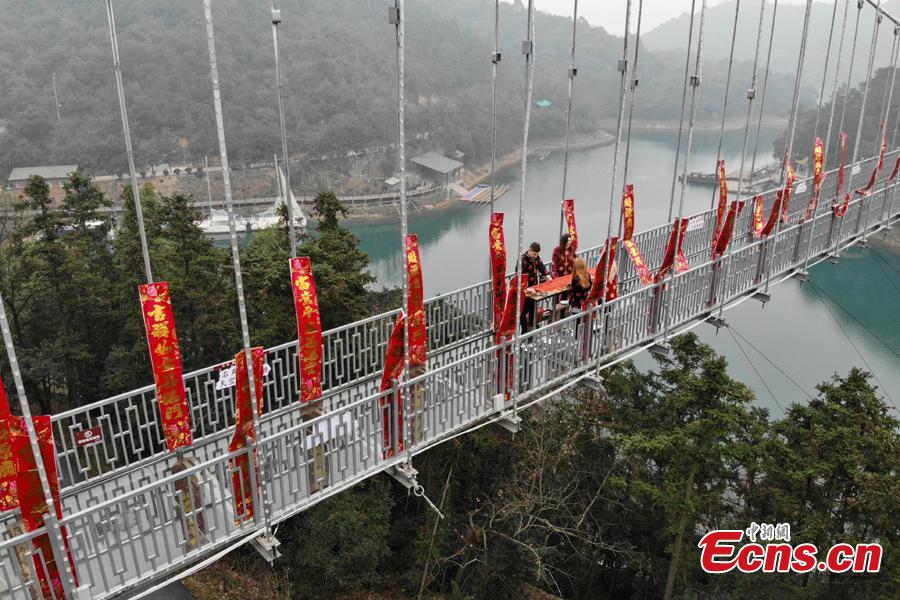 An event to welcome the Spring Festival is held on a suspended glass bridge over the Shiyan Lake in Changsha City, Hunan Province, Jan. 29, 2019. Surrounded by mountains, the lake is a popular tourist attraction. (Photo: China News Service/Yang Huafeng)