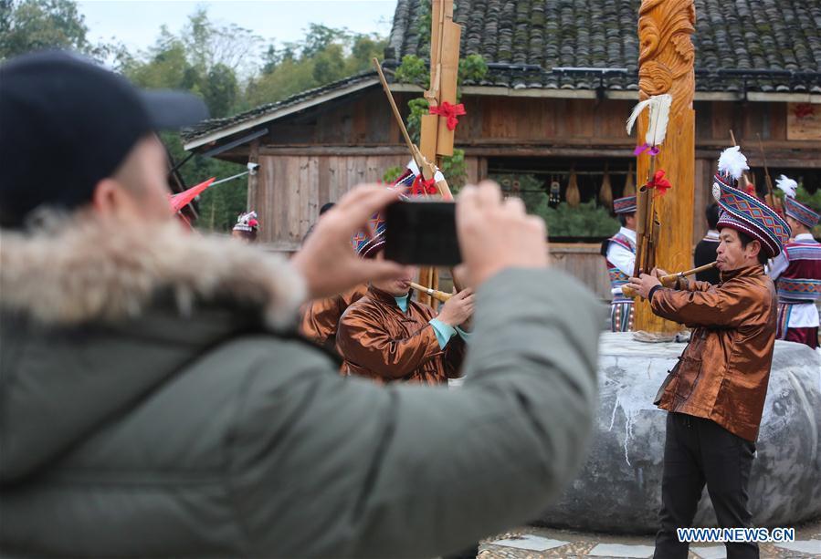 Pan Jiehui plays Lusheng, a reed-pipe wind instrument, in Rongshui Miao Autonomous County, south China\'s Guangxi Zhuang Autonomous Region, Jan. 15, 2019. China\'s efforts and success in poverty reduction can help other developing nations, said experts observing the country\'s ongoing Two Sessions. The Two Sessions refer to the annual gatherings of the National People\'s Congress (NPC) and the National Committee of the Chinese People\'s Political Consultative Conference, China\'s top legislature and political advisory body respectively. China has emerged as a global role model with efforts in structural transformation and industrial upgrading, lifting hundreds of millions of people out of poverty, said retired Lieutenant Colonel Muhammad Faruk Khan, a presidium member of Bangladesh\'s ruling Awami League. (Xinhua/Chen Junqing)