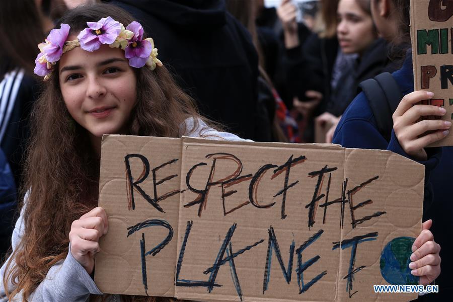 A girl holds a placard in a march against climate change at Syntagma square, in Athens, Greece, March 15, 2019. (Xinhua/Marios Lolos)