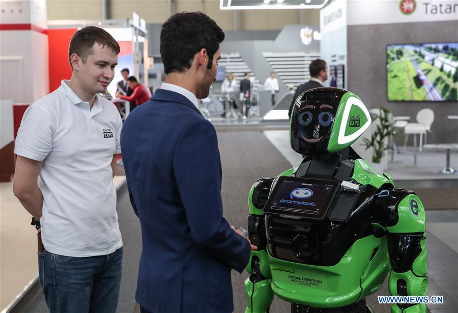 A visitor interacts with a robot at the booth of Russia during the 2019 Hanover Fair in Hanover, Germany, on April 1, 2019. With a total of 6,500 exhibitors from 75 countries and regions, the Hanover Fair shows the latest development of technologies for industrial use, including 5G network, artificial intelligence, light-weight manufacturing, among others. (Xinhua/Shan Yuqi)