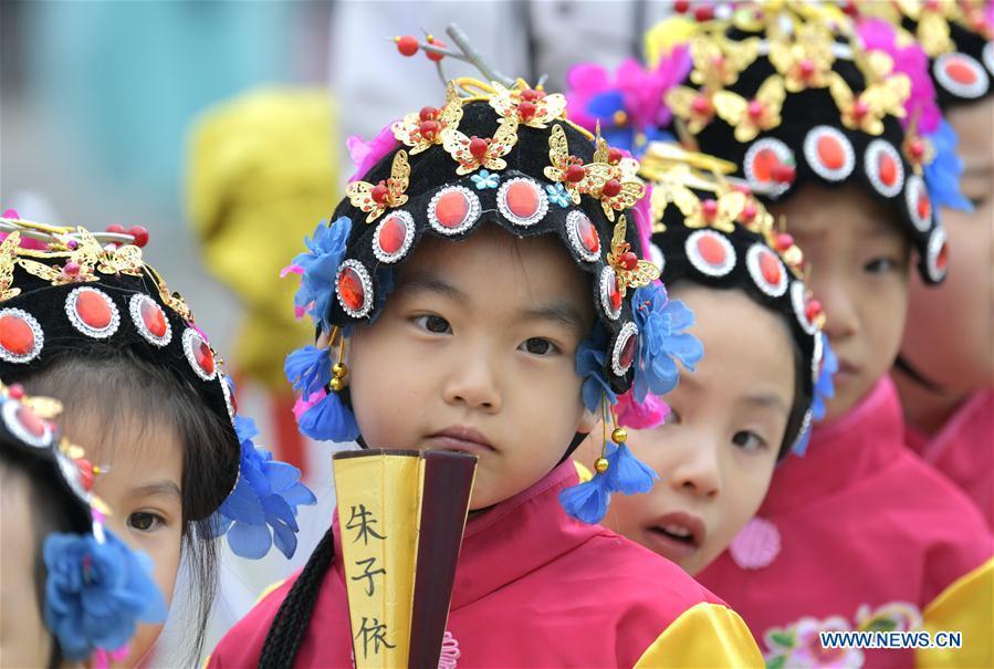 Children wait to perform during an event in celebration of the International Children\'s Day in Xuanen County of Enshi Tujia and Miao Autonomous Prefecture, central China\'s Hubei Province, May 30, 2019. (Xinhua/Song Wen)